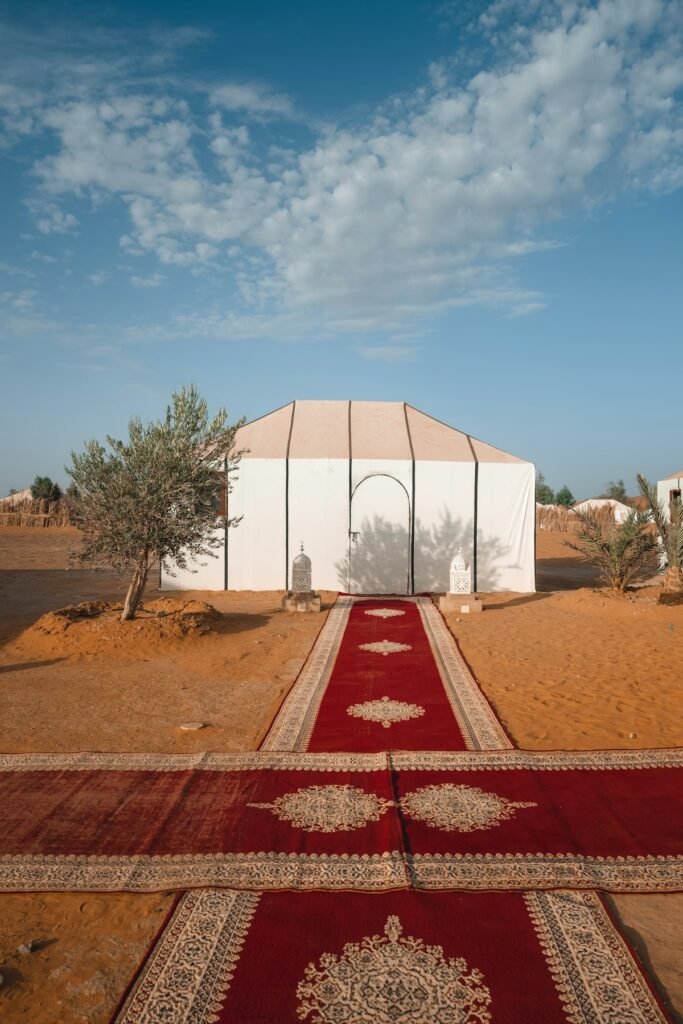 White tent and red carpet at a luxury desert camp, as on the 7-day luxury desert tour in Morocco
