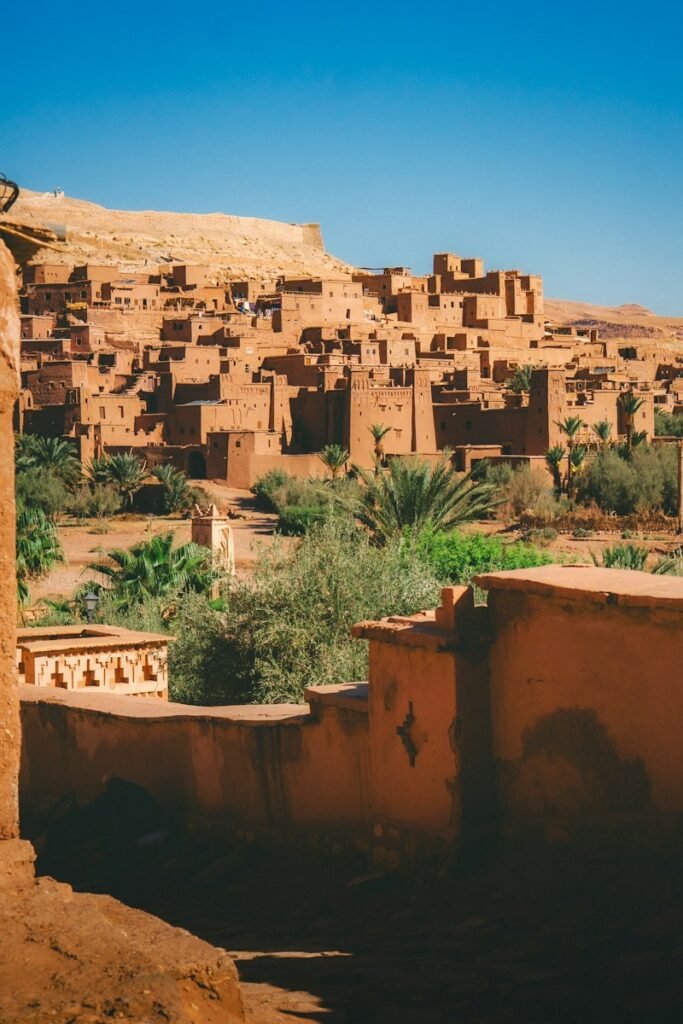 Earthen kasbah village above a palm oasis