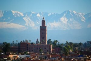 Koutoubia Mosque minaret with the snow-capped Atlas behind Marrakech