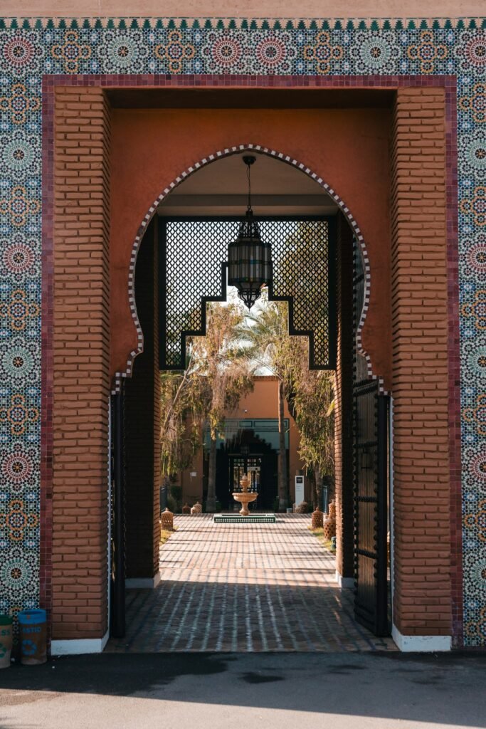 Zellige-framed archway opening onto a garden courtyard in Marrakech
