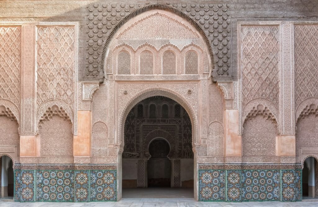 Carved arches around a courtyard in Marrakech, the style of riad booked for the private luxury tour of Morocco